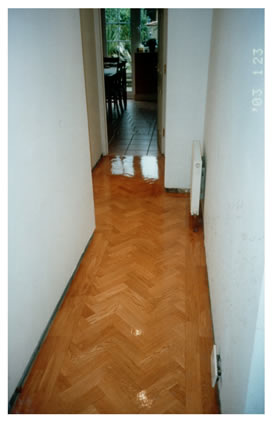 New wood block floor installed in Loughton, Essex.. We installed a new oak wood block floor in a herringbone pattern with border, and sanded and finished..