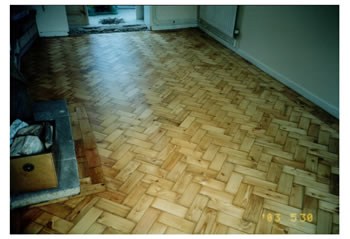 Wood floor stripping and repairs in Much Hadham. We made repairs to this pine wood block flooring in a herringbone pattern..