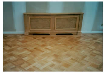 New parquet wood flooring installation in Cambridge. We installed this oak parquet wood flooring in a basket weave pattern with a large dot inset design and mahogany two-line border..