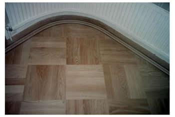 New parquet wood floor installation in Potters Bar. Parquet wooden flooring in basket weave pattern with a curved border..