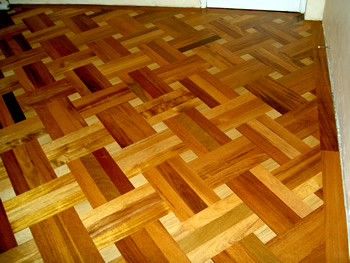 New parquet wood flooring in Stamford Hill. Merbau parquet wood floor in basket weave pattern with small oak dot..