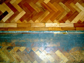 Wood floor sanding in Presdales School, Hertfordshire. Herringbone floorboard sanding in Hertfordshire..