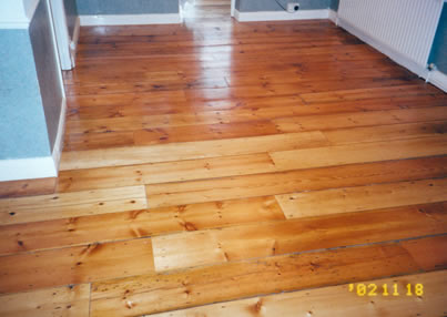 Reclaimed pine floor boards in Islington. We stripped and sanded this existing pine wood flooring..